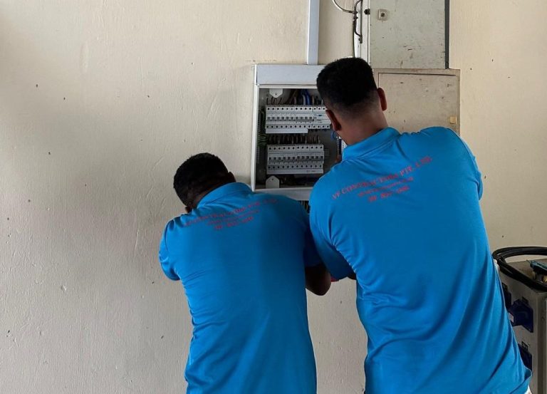 Two VF Contractors electricians wiring a distribution board