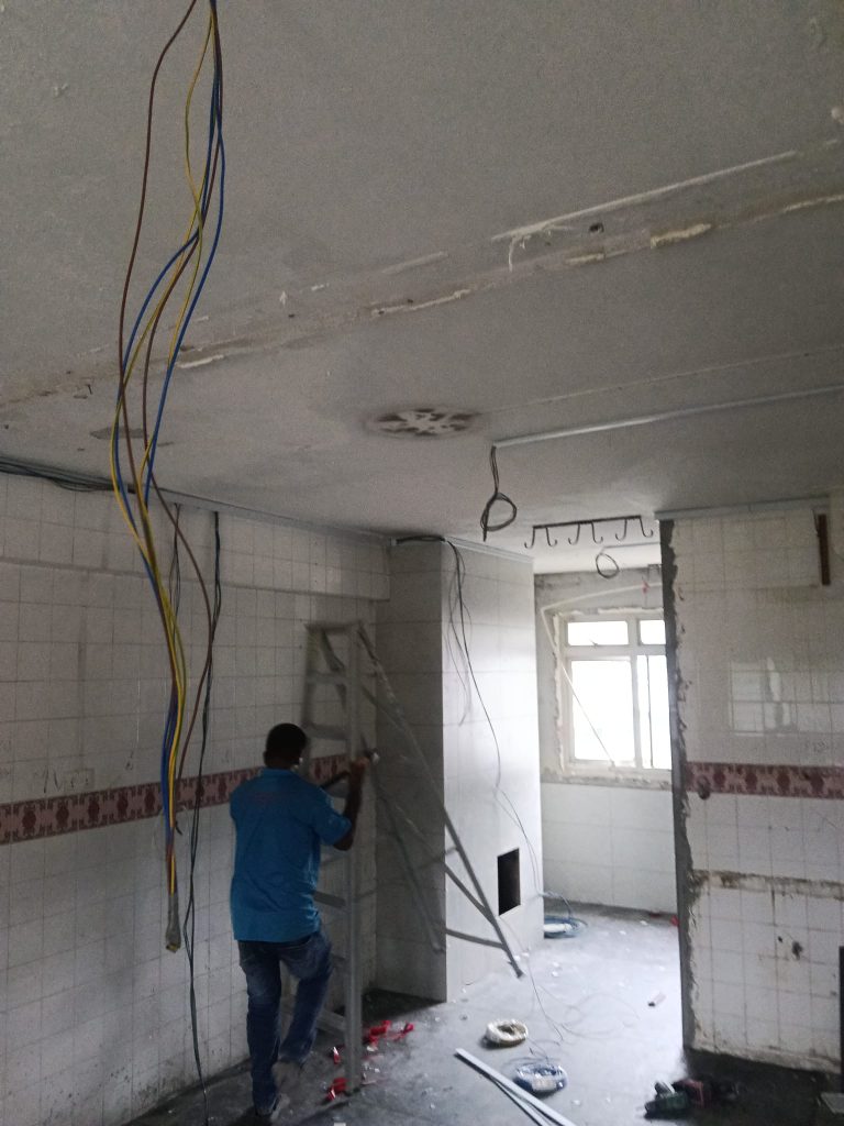 Electrician rewiring an HDB kitchen